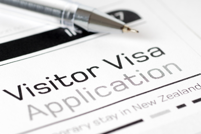 visitor visa application form with pen
